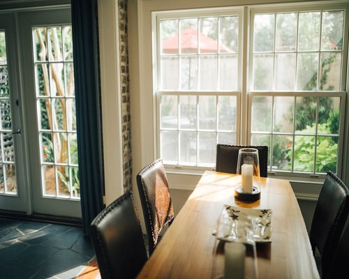 Laptop on a dining table with a coffee cup nearby